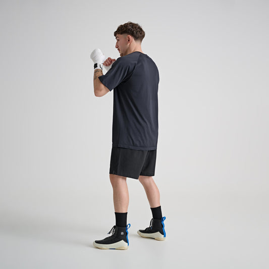 Model wearing YAMMY Flux Mid Black/Bone boxing boots