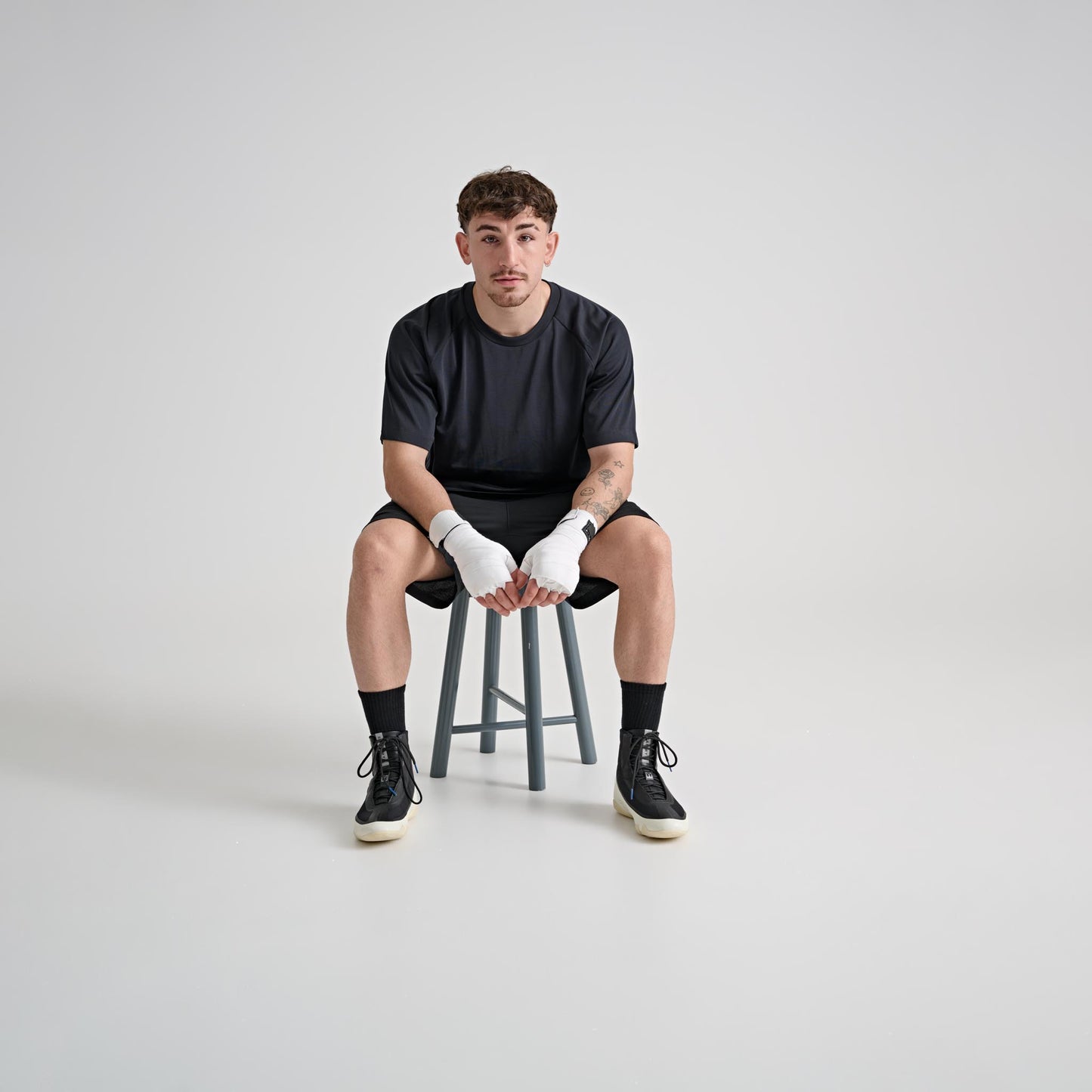Model wearing YAMMY Flux Mid Black/Bone boxing boots