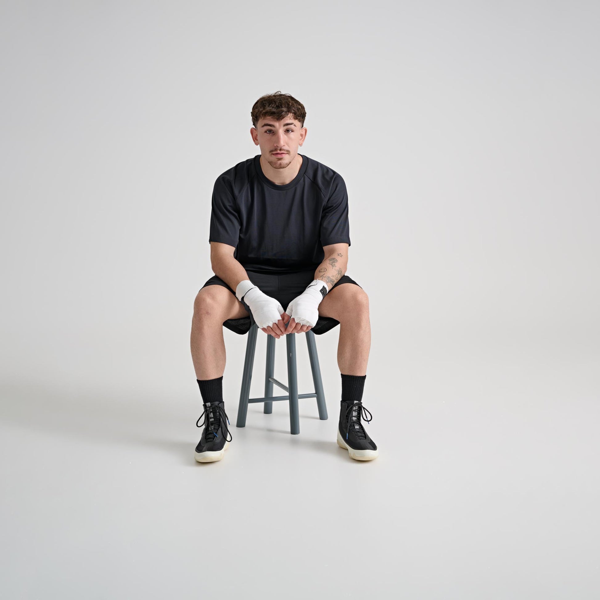 Model wearing YAMMY Flux Mid Black/Bone boxing boots