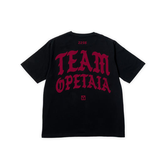 A black short-sleeve t-shirt shown from the back, featuring a large red gothic-style graphic that reads 'TEAM OPETAIA' across the back, with '2259' printed in red near the collar and a small red square logo below the text.