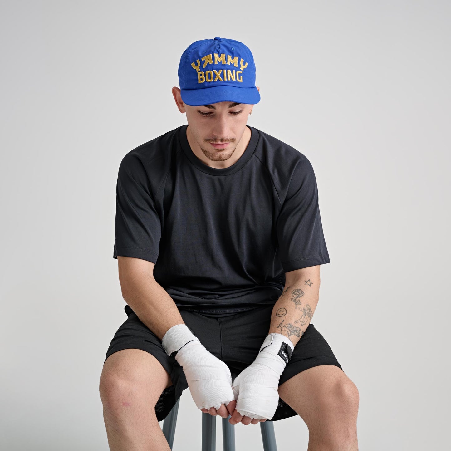 Model wearing YAMMY Blockbuster Cap Blue/Gold