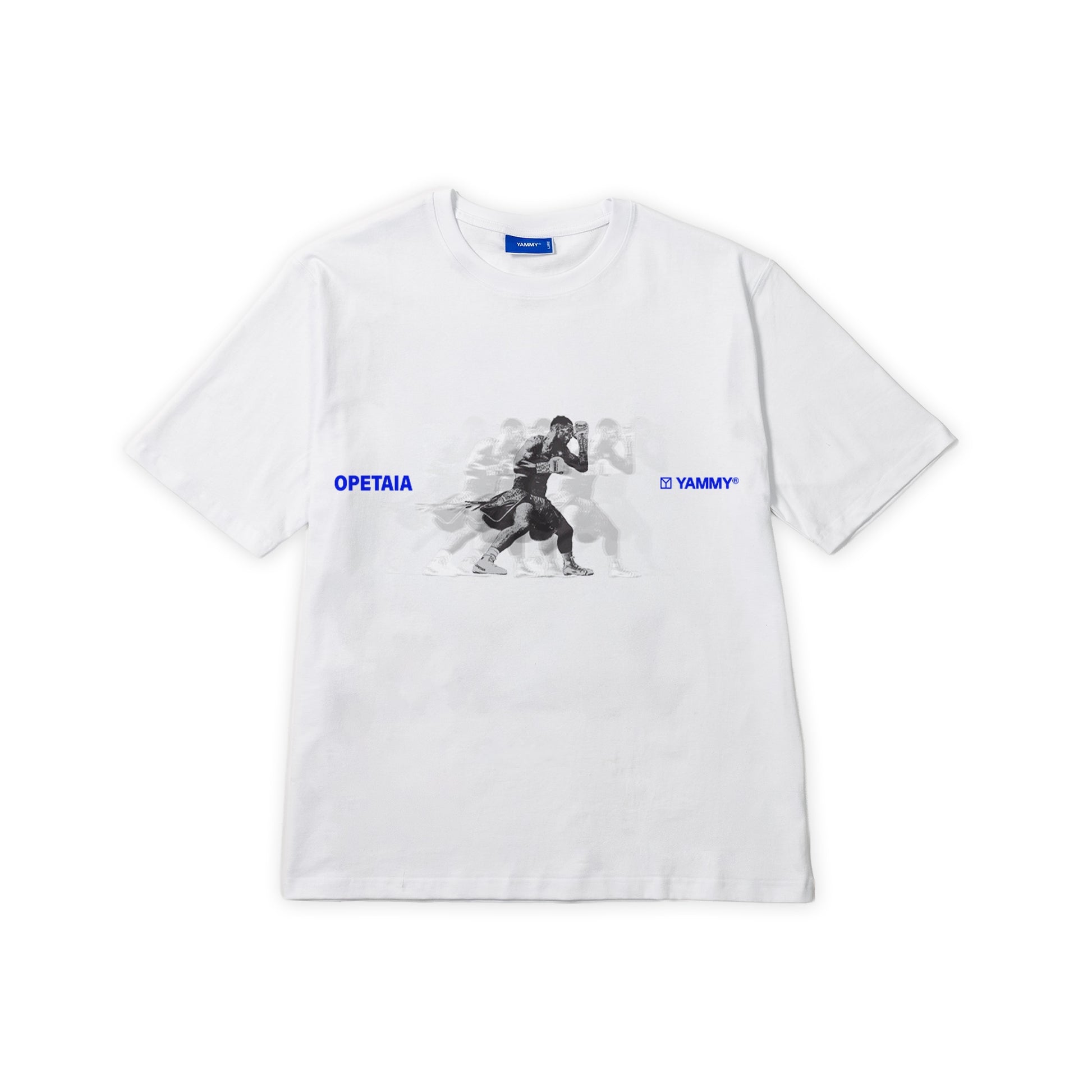 A white short-sleeve crewneck t-shirt featuring a central graphic of Jai Opetaia in black and white, with blue text reading 'OPETAIA' on the left chest and 'YAMMY' on the right chest.