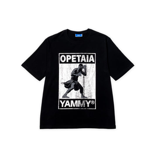 A black short-sleeve t-shirt with a distressed white graphic print on the front featuring Jai Opetaia and the text 'OPETAIA' and 'YAMMY'.