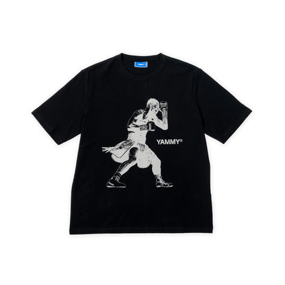 A black short-sleeve t-shirt with a white graphic print of Jai Opetaia and the text 'YAMMY' on the front, displayed flat against a white background.