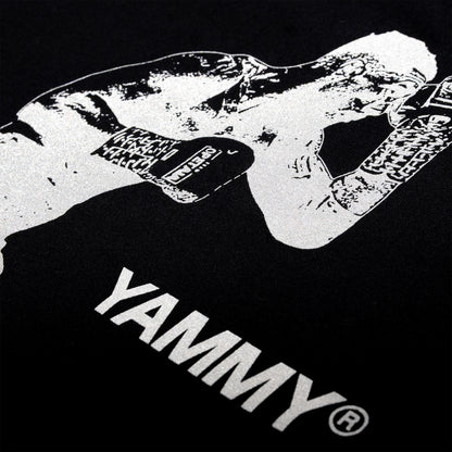 Close-up of a black T-shirt featuring a high-contrast white graphic of a fighter wearing gloves, with the word 'YAMMY' printed in large white letters below.