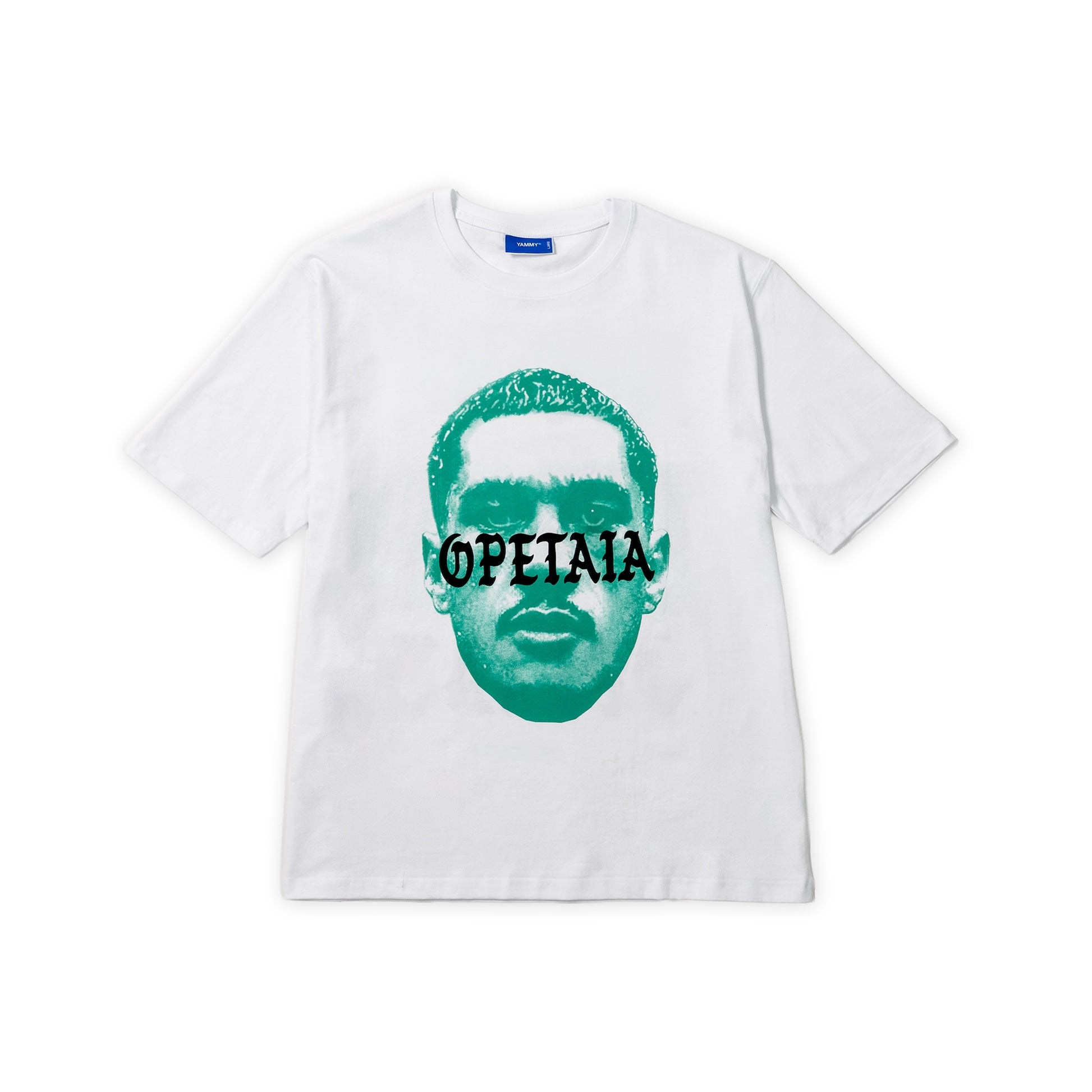 A white short-sleeve crewneck t-shirt featuring a stylized teal graphic of Jai Opetaia with the word 'OPETAIA' printed across the eyes, displayed flat against a white background.