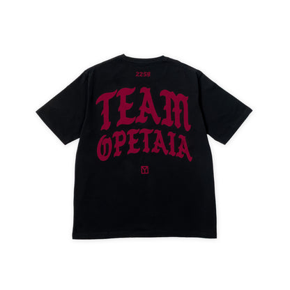 A black short-sleeve t-shirt shown from the back, featuring a large red gothic-style graphic that reads 'TEAM OPETAIA' across the back, with '2259' printed in red near the collar and a small red square logo below the text.