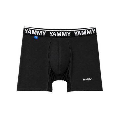 Black boxer briefs with a white elastic waistband featuring the brand name 'YAMMY' repeated in white, plus a small blue size tag and a white YAMMY logo near the lower right leg.