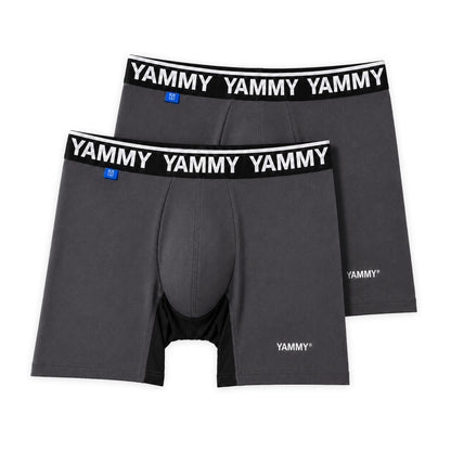 Two dark gray boxer briefs with black elastic waistbands featuring the white YAMMY logo, displayed on a clean white background.