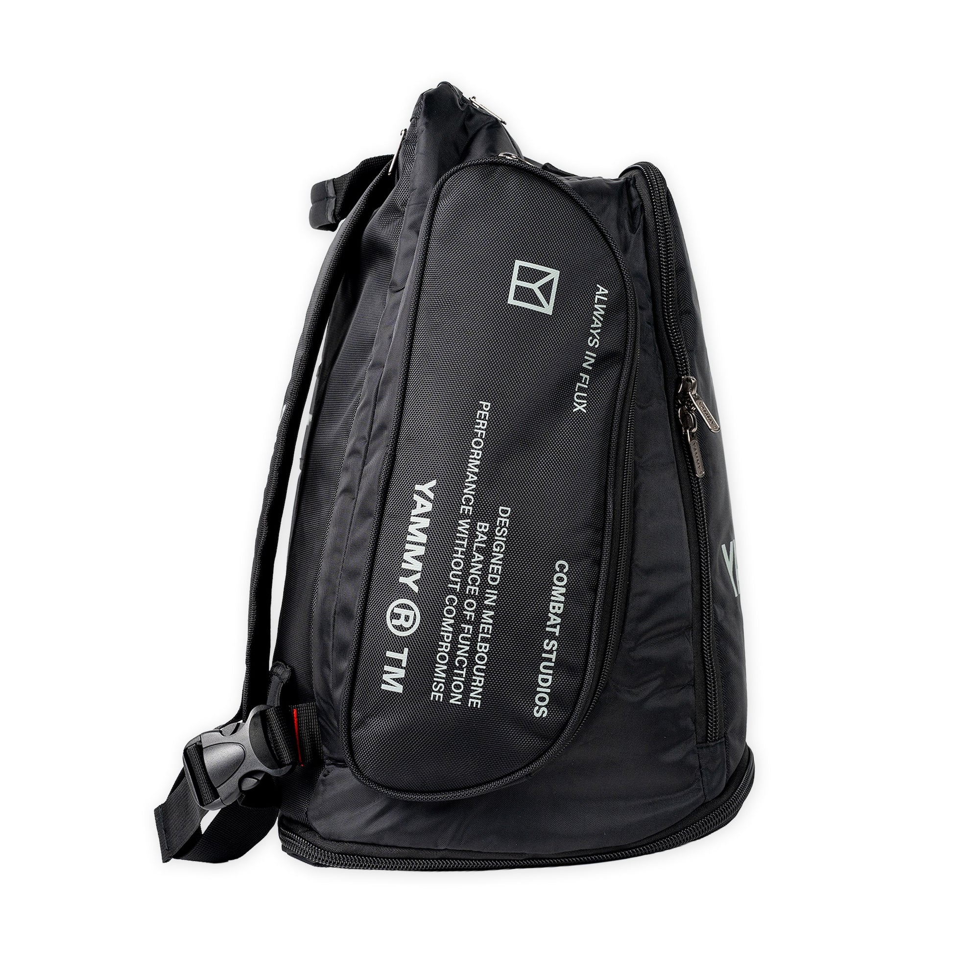 A black nylon backpack with white printed text and logos, including 'YAMMY' and 'COMBAT STUDIOS', shown on a plain white background.