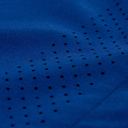 Close-up of a dark blue athletic fabric with a pattern of small perforated holes.