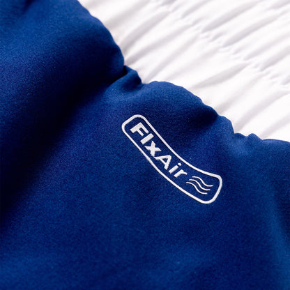 A close-up of a royal blue fleece or fabric item with a white embroidered 'FIXAir' logo, resting against a white textured background.