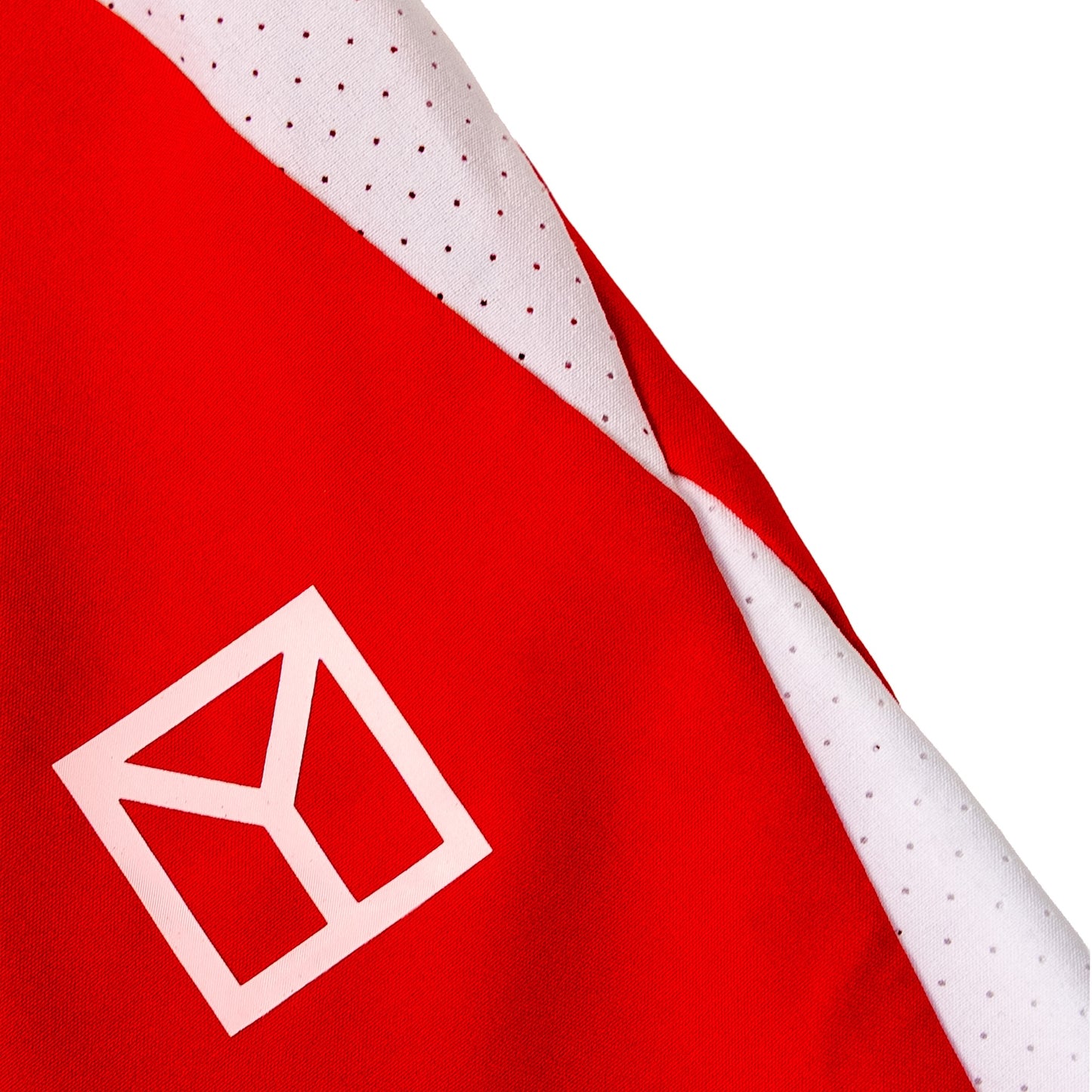 Close-up of a red fabric product with a white geometric logo and a white perforated trim detail on a white background.
