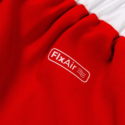 Close-up of a bright red fabric product with a white embroidered FixAir logo patch, showing the brand name and small wave graphic.