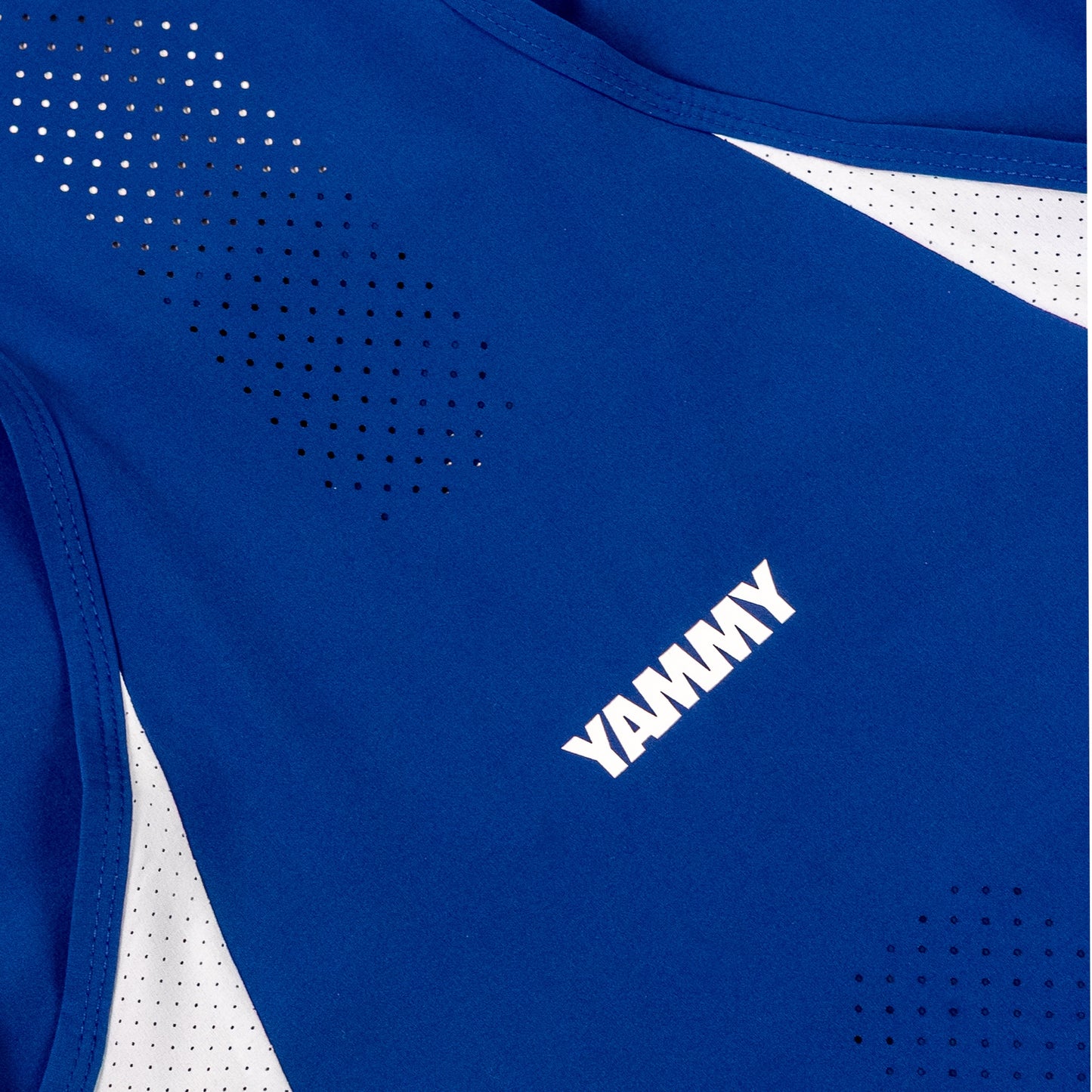 Close-up of a royal blue athletic top with white mesh side panels and a white YAMMY logo printed on the chest.