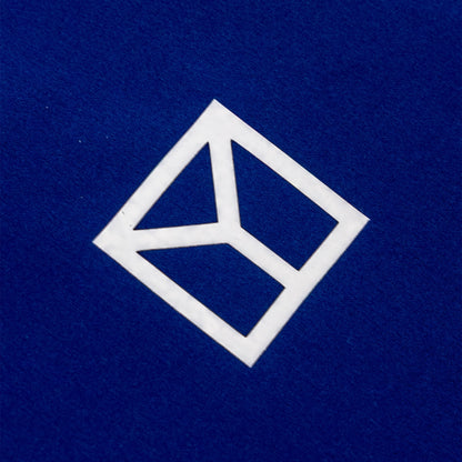 A white geometric logo decal or sticker on a textured dark blue background.