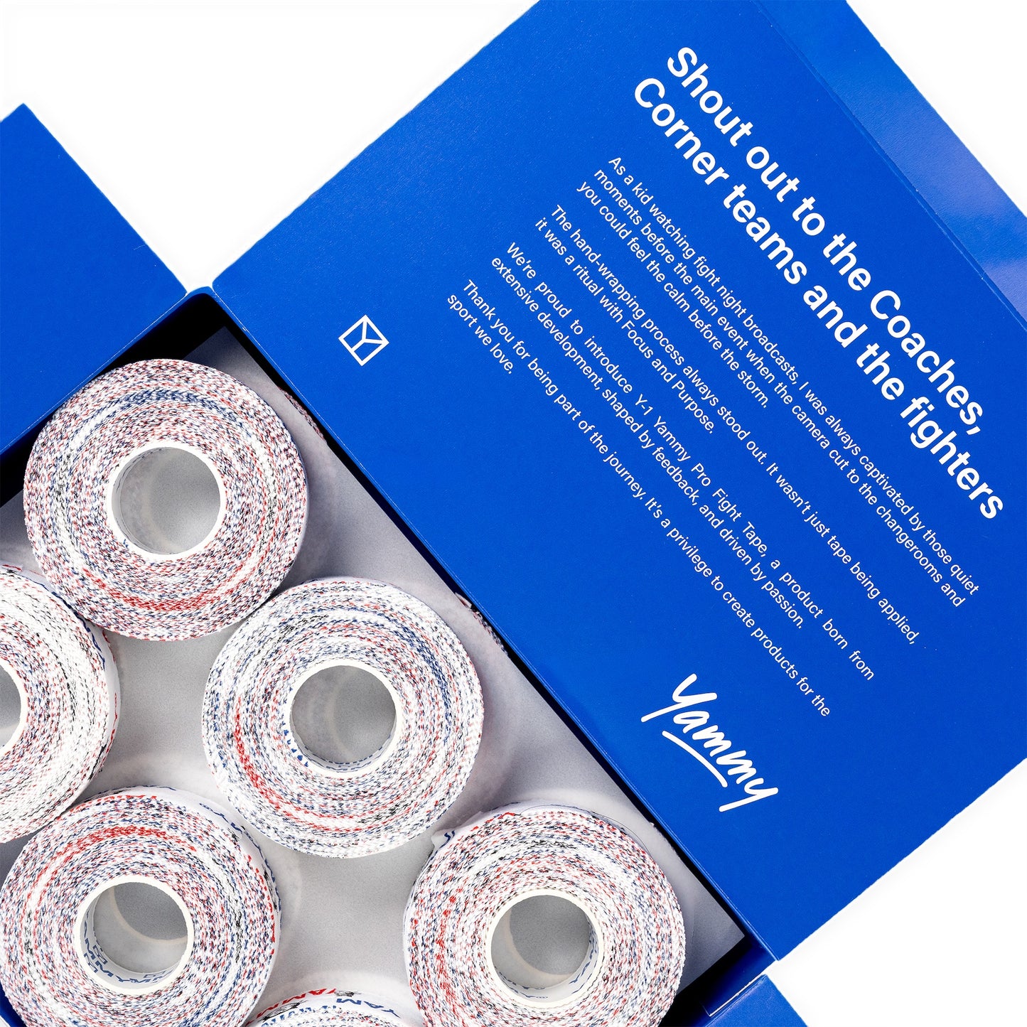 An open blue YAMMY box showing several rolls of multicolored athletic corner tape inside, with printed white text on the inside lid.