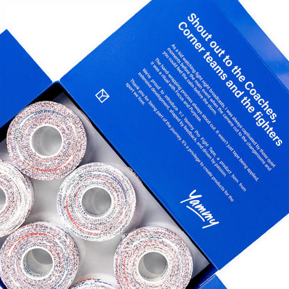 An open blue YAMMY box showing several rolls of multicolored athletic corner tape inside, with printed white text on the inside lid.
