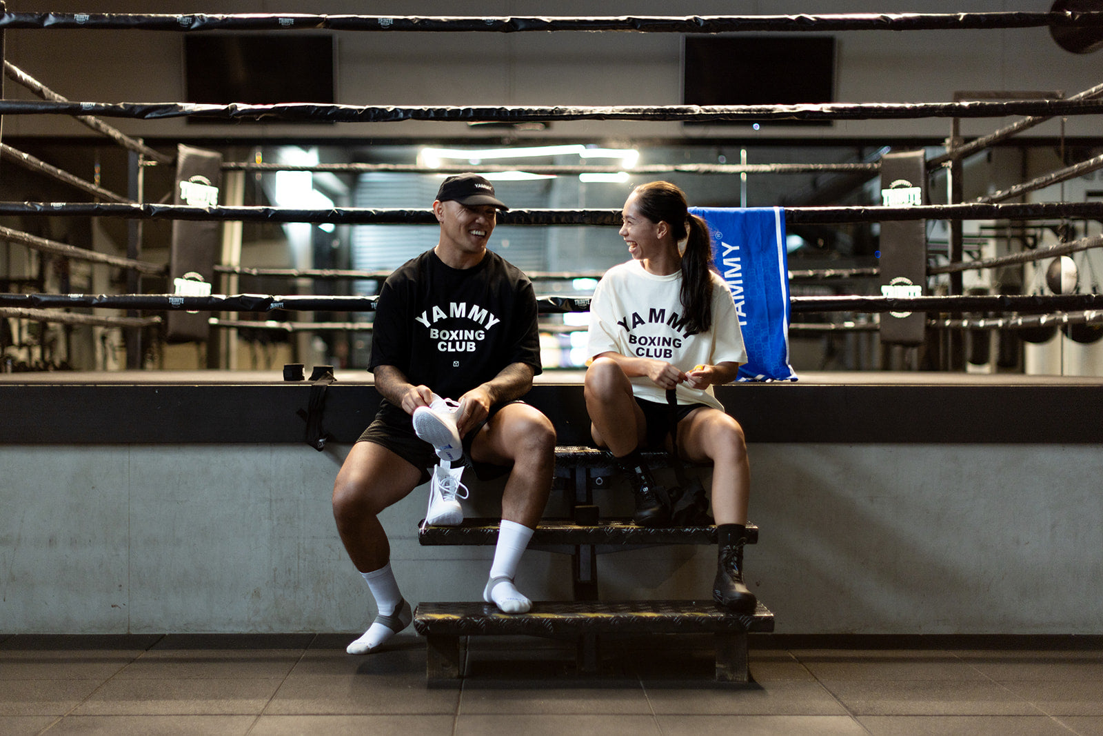 Two models wearing YAMMY Club T-Shirt near the boxing ring